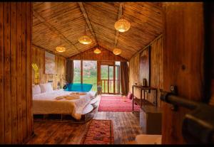 a bedroom with a bed in a wooden room at Riad Atlas Bangalow in Imlil