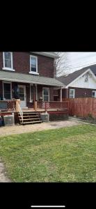 a brick house with a porch and a fence at 2 Bedroom Cozy Accommodation in Windsor