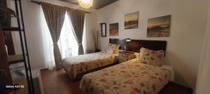 a hotel room with two beds and a window at Casa Mestre Guesthouse in Vila do Bispo +76 photos