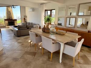 a kitchen and living room with a wooden table and chairs at Villa Grand Zeus in Anoyira +28 photos