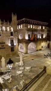 a large building with tables and chairs in front of it at Casa riera in Valderrobres +2 photos