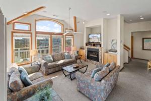 a living room with couches and a fireplace at AV13 Time Away in Avon