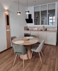 a kitchen with a wooden table and chairs in a room at Sweet Apartment Aveiro Station in Aveiro +16 photos