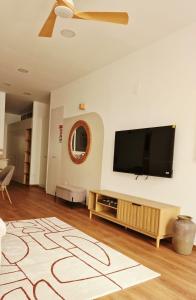 a living room with a flat screen tv on a wall at Sweet Apartment Aveiro Station in Aveiro