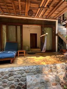 a porch with a hammock on a house at La baxada mazunte in Mazunte +7 photos