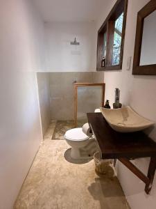 a bathroom with a sink and a toilet at La baxada mazunte in Mazunte