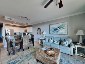 a living room with a blue couch and a table at The Indies #209 in Fort Morgan