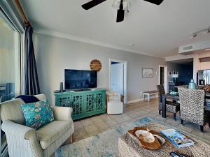 a living room with a couch and a tv at The Indies #209 in Fort Morgan