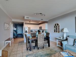 a kitchen and living room with a table and chairs at The Indies #209 in Fort Morgan