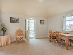 a dining room with a table and chairs at The Saddlery - Uk36123 in Horsington