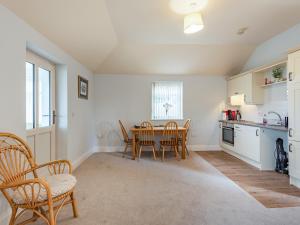 a kitchen and dining room with a table and chairs at The Saddlery - Uk36123 in Horsington +11 photos
