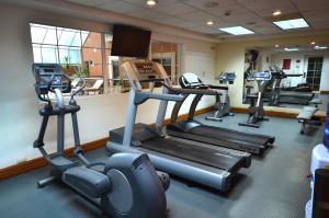 a gym with several tread machines in a room at iStay Hotel Ciudad Victoria in Ciudad Victoria