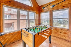 a foosball table in a room with windows at AV175 Sandfiddler 175 in Avon