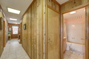a bathroom with wooden walls and a toilet at AV175 Sandfiddler 175 in Avon +26 photos