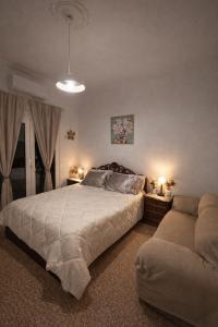 a bedroom with a large bed and a couch at Mytilene Heritage Loft 3A2 in Mytilene +20 photos