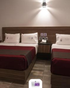 a hotel room with two beds and a price sign on it at Tulamor Love Suites & Villas in San Lorenzo