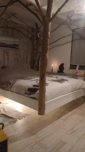 a bedroom with a bed with a tree on it at Villas Paradis in Saint-Paul-lès-Dax +17 photos
