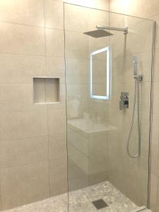a shower with a glass door with a sink at 232F South Finger in Jolly Harbour +22 photos