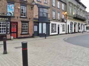 an empty street in a city with brick buildings at Hogwood Cottage in Knaresborough +1 photo