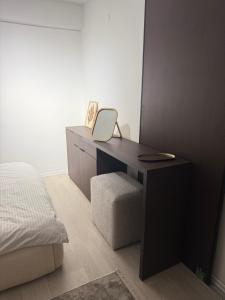 a bedroom with a desk with a bed and a mirror at Deluxe Apartment 1 in Gnjilane +4 photos