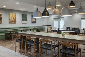 a restaurant with a large table and chairs at Fairfield Inn & Suites Lake City in Lake City