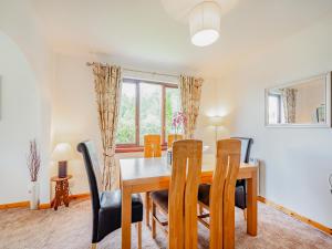 a dining room with a wooden table and chairs at Glenview in Appin