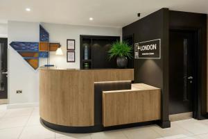 a lobby of a hotel with a reception desk at Four Points Flex by Sheraton London Kensington Olympia in London
