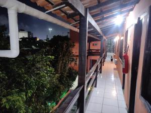 an empty corridor of a building at night at Pousada Vento Leste in Cabo Frio +10 photos