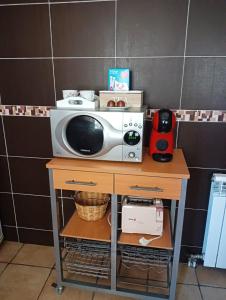 a microwave sitting on a table in a kitchen at KyN in Cornago