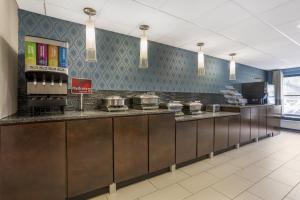 a kitchen with a counter with pots and pans at Best Western Plus Tallahassee North Hotel in Tallahassee