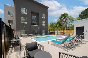a patio with chairs and a swimming pool at TownePlace Suites Longview in Longview