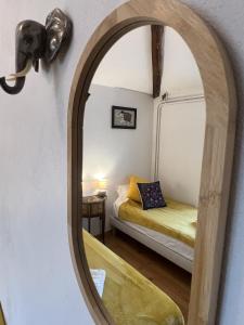 a mirror in a room with a bed at Au pré du puy in Chambretaud +16 photos