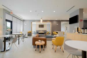 a lobby with tables and chairs and a cafeteria at TownePlace Suites Longview in Longview