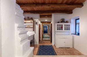 a kitchen with white cabinets and a hallway at NohaTerény in Terény +23 photos