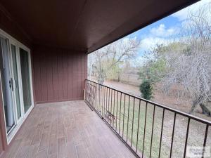 a balcony of a house with a large window at 305 Calle Amistosa in Brownsville