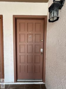 a brown door with a light next to a building at 305 Calle Amistosa in Brownsville