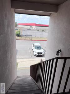 a stairway with a car parked in a parking lot at 305 Calle Amistosa in Brownsville +5 photos
