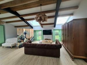 a large living room with a couch and a bed at El Sueño, Parrita in Barres