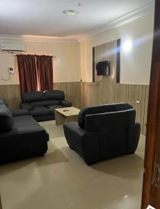 a living room with two couches and a table at DE-George's Grand Resort in Mama
