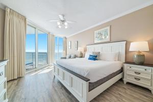 a bedroom with a bed with a view of the ocean at Palacio Unit 403 in Pensacola