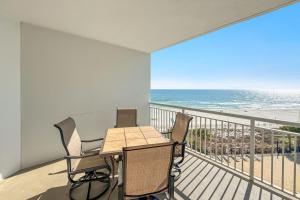 a balcony with a table and chairs and the ocean at Palacio Unit 403 in Pensacola