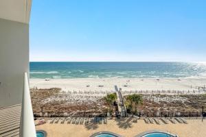 a view of a beach with chairs and the ocean at Palacio Unit 403 in Pensacola