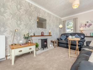 a living room with a couch and a fireplace at Tanera in Wick