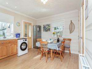 a kitchen and dining room with a table and chairs at Tanera in Wick