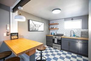 a kitchen with a table and a sink and a stove at Rose Park Hideaway in Missoula +14 photos