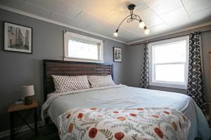 a bedroom with a large bed and two windows at Rose Park Hideaway in Missoula