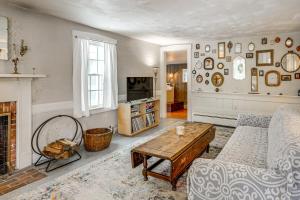 a living room with a couch and a fireplace at Historic 1820s Homestead on Battenkill River! in Arlington