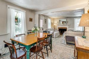 a living room with a wooden table and chairs at Historic 1820s Homestead on Battenkill River! in Arlington