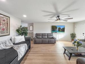 a living room with a couch and a ceiling fan at Gather Together home in Montrose +37 photos
