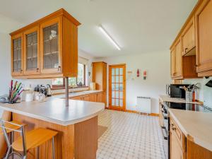a kitchen with wooden cabinets and a counter top at Glenview in Appin